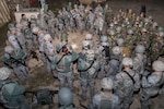 Students from the Inter-American Air Force Academy’s 837th Training Squadron and 343rd TRS attend a pre-mission briefing at Joint Base San Antonio-Camp Bullis as part of their final training exercise Nov. 8, 2017. The students practiced reconnaissance, ambush, searching, and patrolling tactics. This was the first time the 837th TRS and 343rd TRS partnered for joint training.