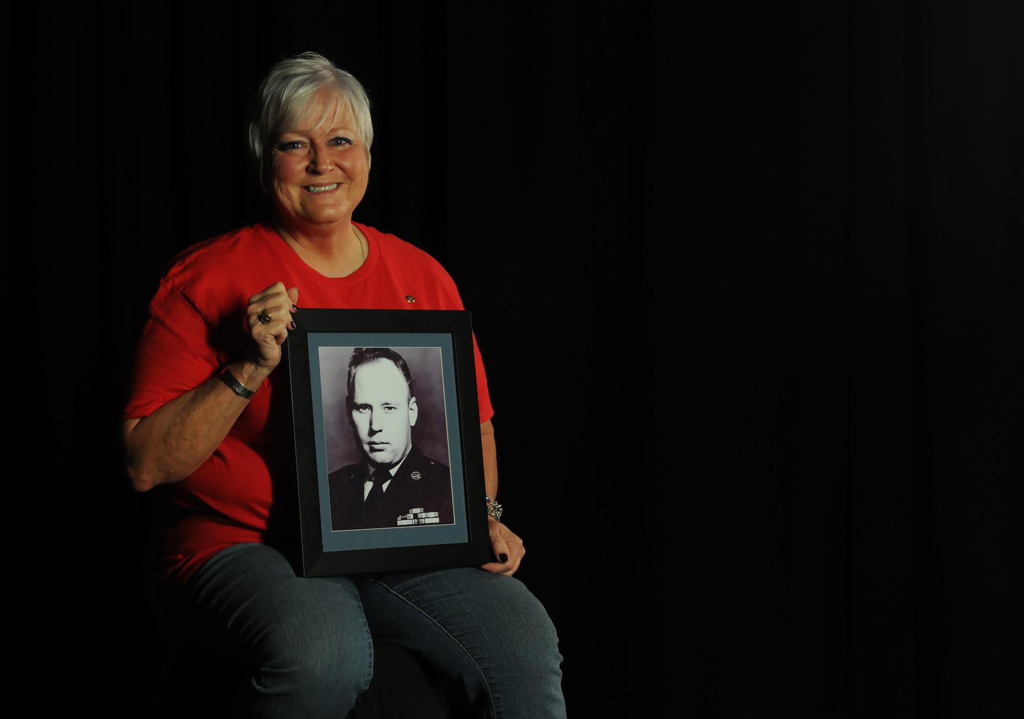 Nora Moore, daughter of Chief Master Sgt. Thomas Moore, Vietnam War prisoner of war and missing in action, holds a photo of her dad, Sept. 22, 2017, on Keesler Air Force Base, Mississippi. Thomas Moore was captured in South Vietnam by the Viet Cong and has been listed as a POW/MIA due to his remains not being found. Nora, was recently recognized as the first person in Keesler history to receive Gold Star Family status. (U.S. Air Force photo by Senior Airman Holly Mansfield)