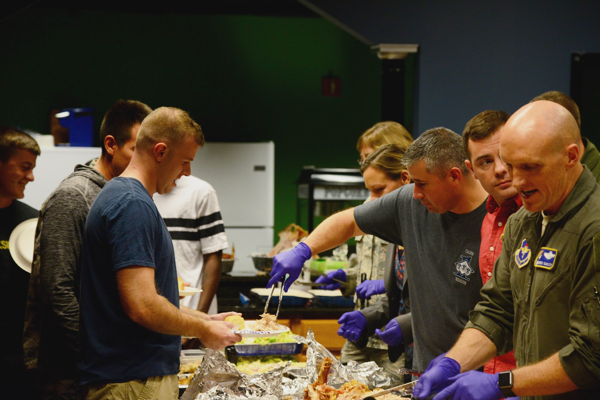 First sergeants and base leadership serve Airmen living at the Unaccompanied Enlisted Quarters a Thanksgiving meal at Dormsgiving Nov. 16, 2017, at Columbus Air Force Base, Mississippi. After everyone had eaten, leadership then sat beside and mingled with the Airmen, talking about their goals and offering any advice to their less experienced wingmen. (U.S. Air Force photo by Airman 1st Class Beaux Hebert)