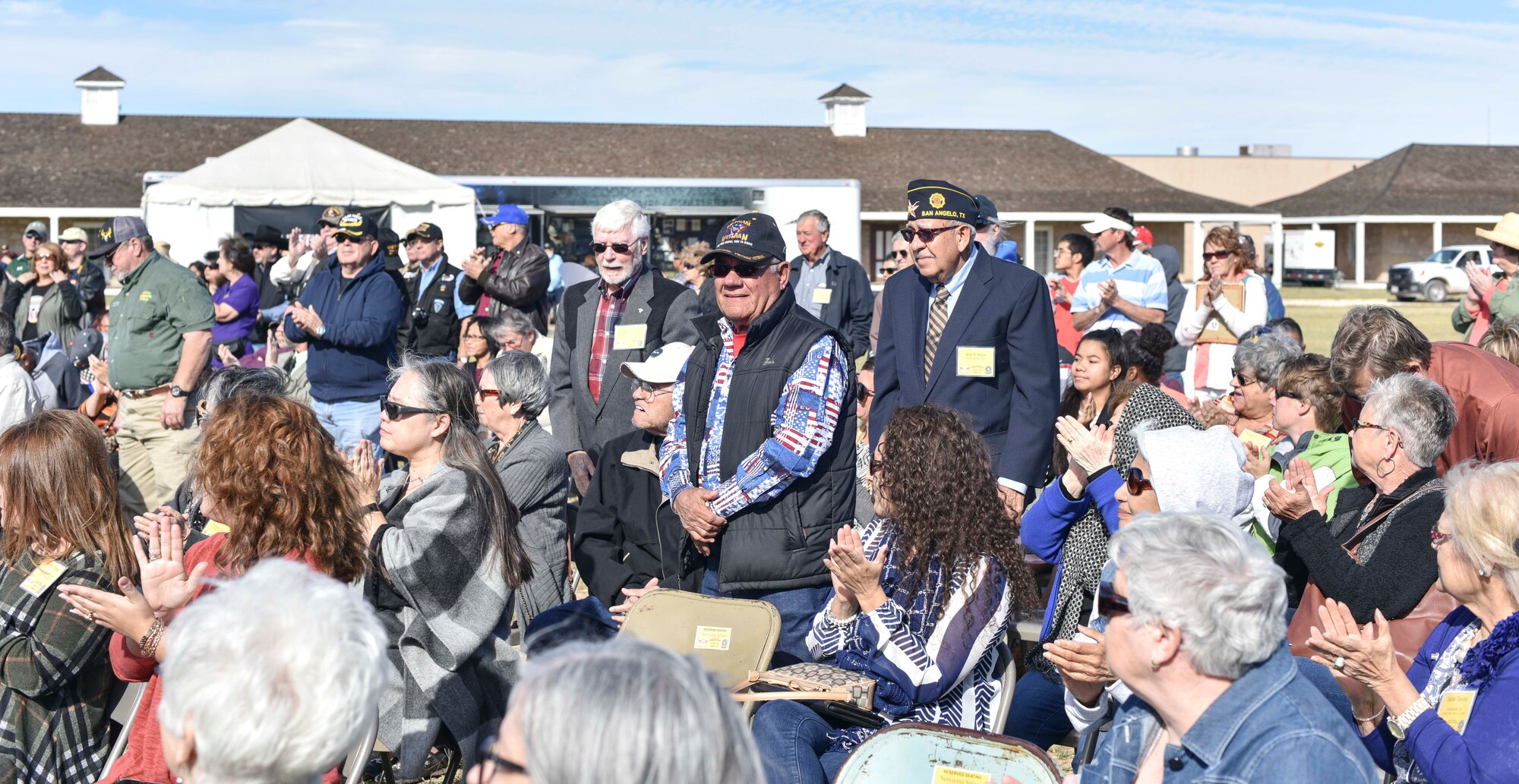 Veterans stand in recognition of their branches’ song during the 50th Vietnam War Commemoration at the Fort Concho parade ground in San Angelo, Texas, Nov. 18, 2017.  The event recognized, thanked and honored United States military veterans and the families of those who died during the Vietnam War. (U.S. photo by Airman 1st Class Randall Moose/released)