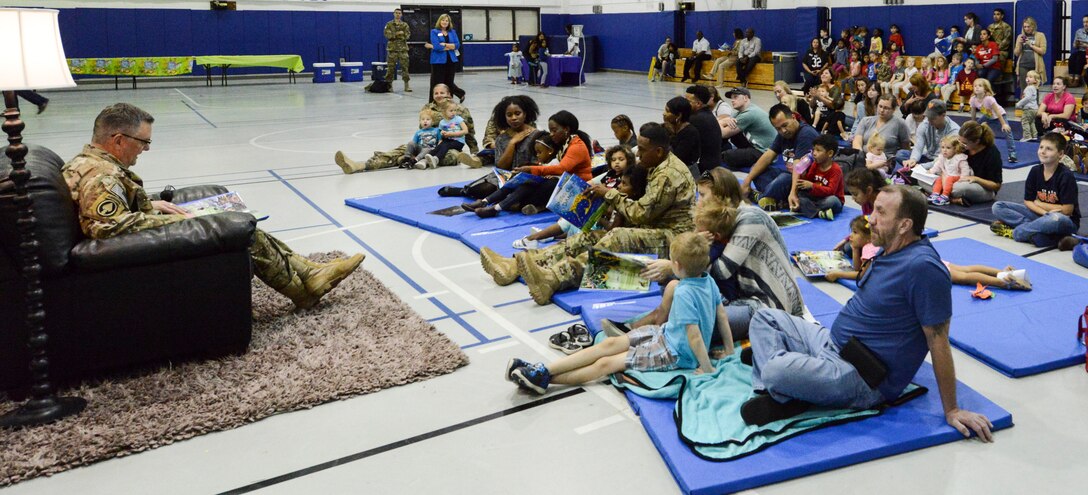 Lt. Gen. Brad Webb, commander of Air Force Special Operations Command, reading a book to more than 60 people.