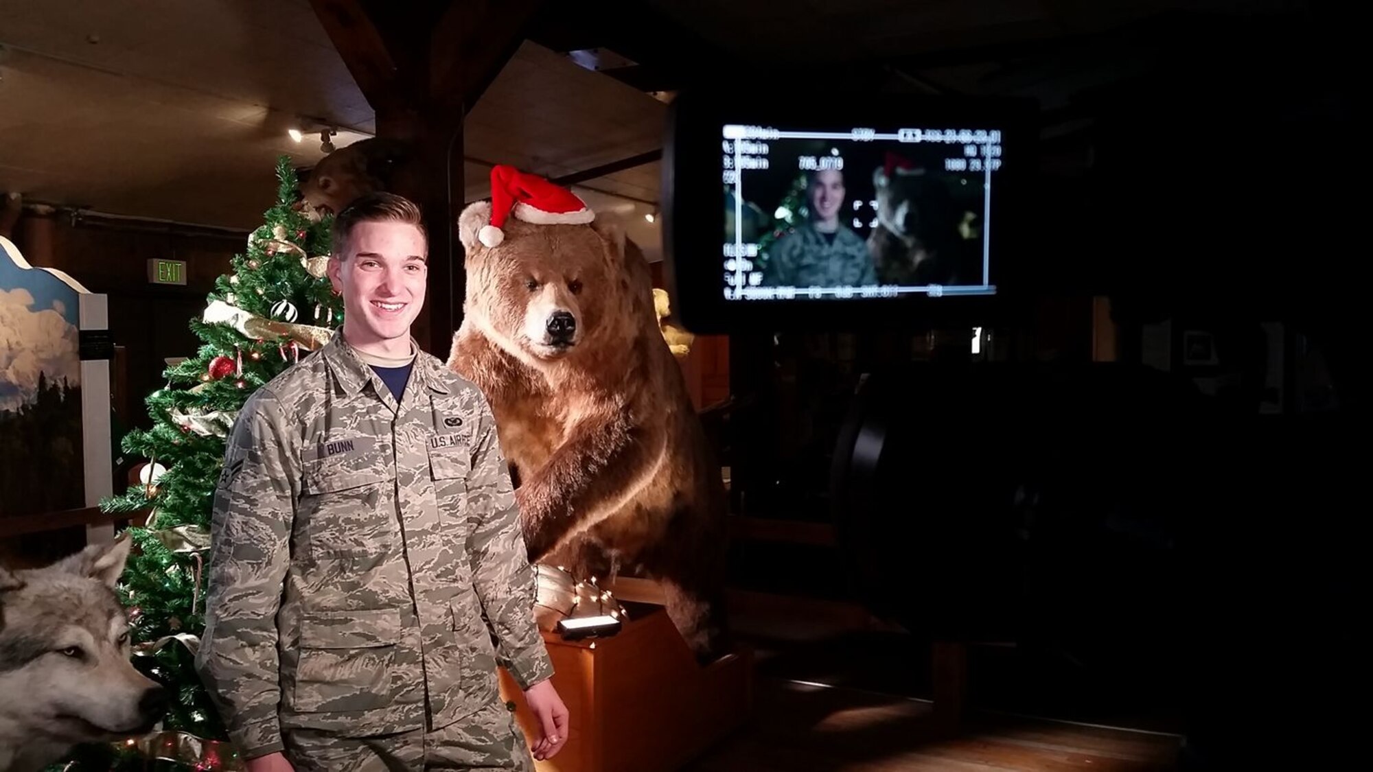 Senior Airman Jared Bunn, 673d Air Base Wing Public Affairs broadcaster, checks his camera gear during last year’s holiday greetings event at Joint Base Elmendorf-Richardson, Alaska. Holiday greetings are a way for service members to send a message to their families back home if they can’t make it themselves.