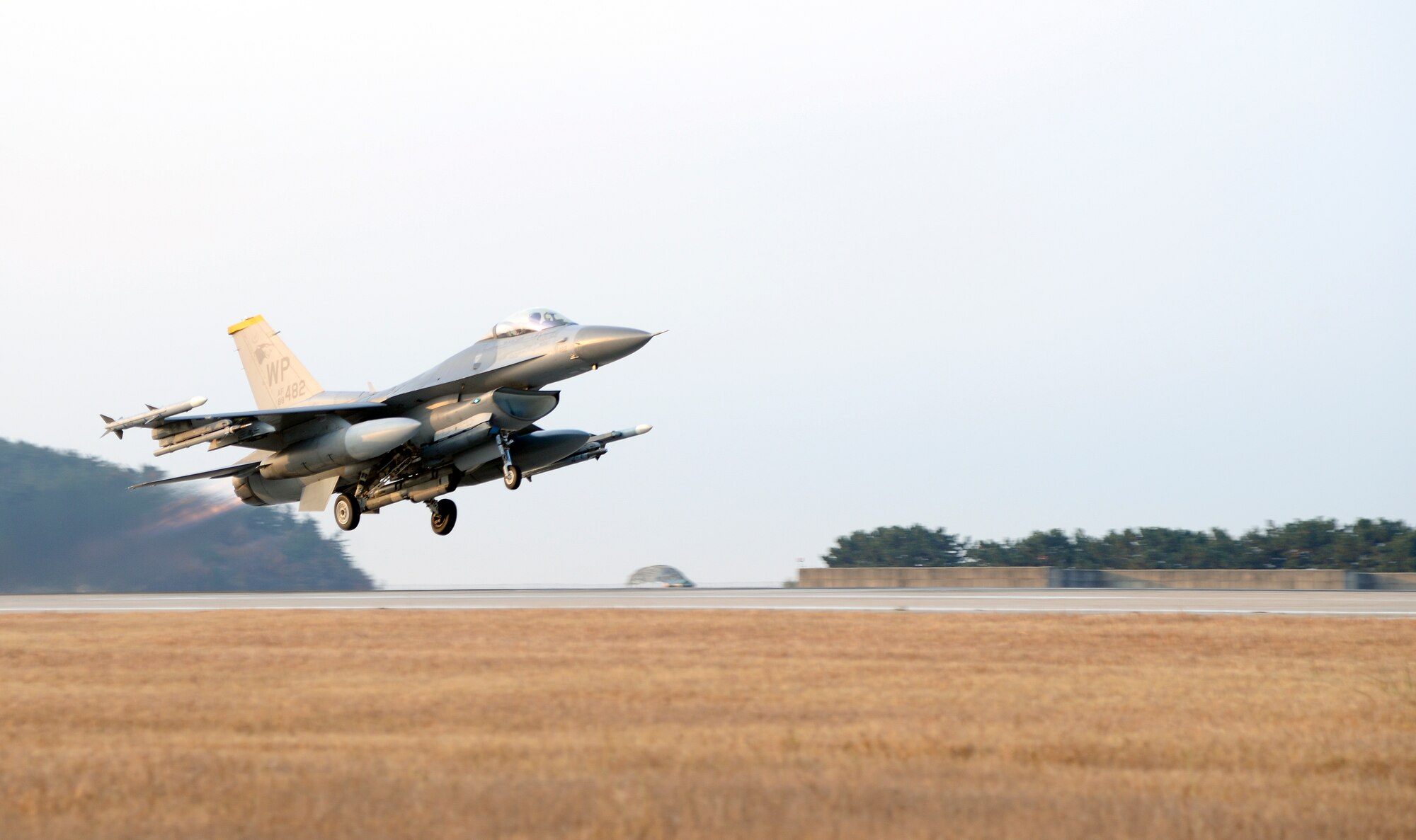A U.S. Air Force F-16 Fighting Falcon with the 80th Fighter Squadron takes off from Kunsan Air Base, Republic of Korea, Nov. 17, 2017 during a large force employment drill in which the 8th Fighter Wing launched more than 20 jets, testing the combat operations with a larger number of aircraft. The 8th FW regularly tests its ability to launch a large number of jets in a short amount of time. (U.S. Air Force photo by Senior Airman Colby L. Hardin)