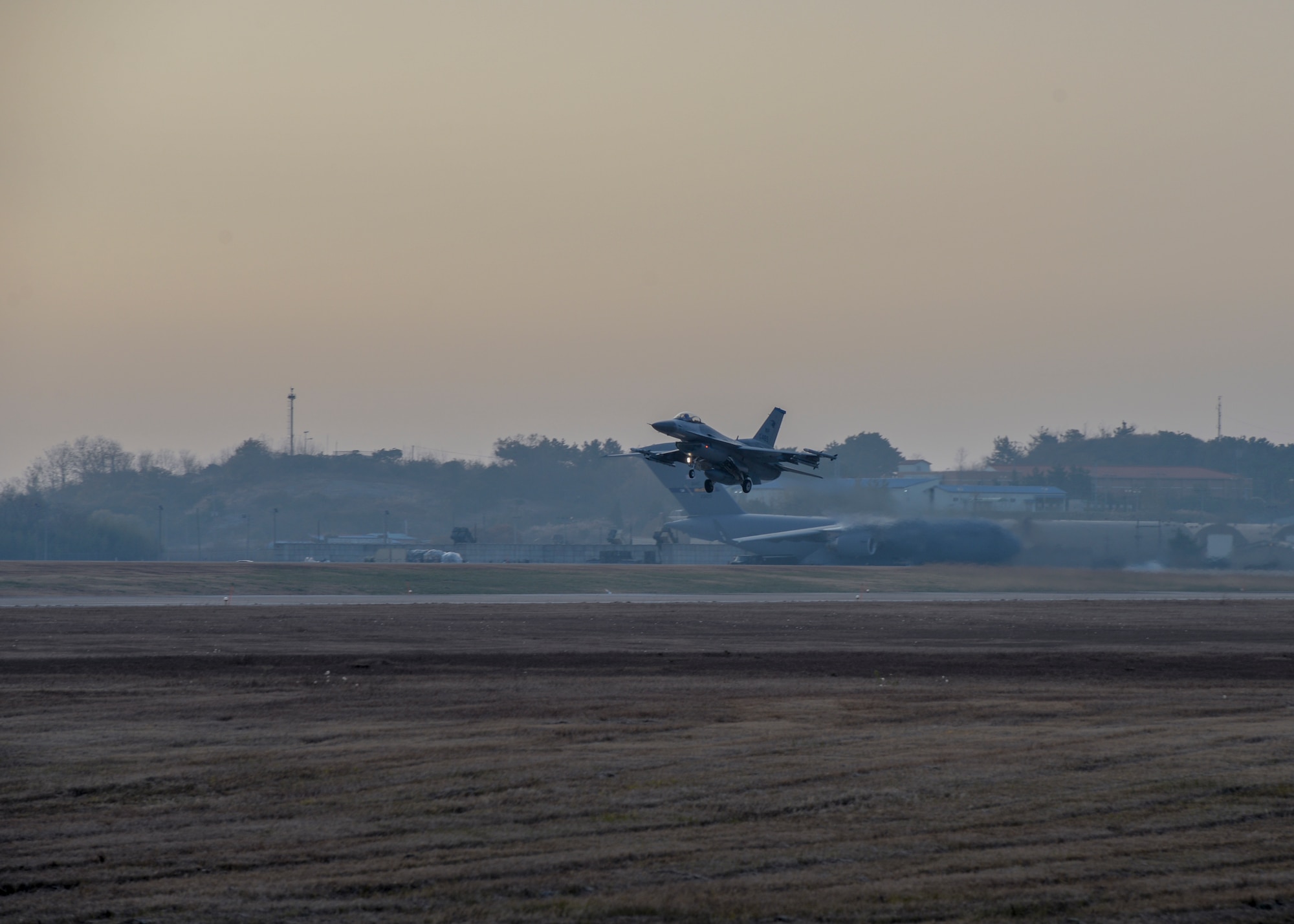 A U.S. Air Force F-16 Fighting Falcon with the 35th Fighter Squadron takes off from Kunsan Air Base, Republic of Korea, Nov. 17, 2017 during a large force employment drill in which the 8th Fighter Wing launched more than 20 aircraft to test its ability to conduct combat operations with large numbers jets in the air. The 8th FW regularly tests its ability to conduct LFEs in exercises and regular training, which gives pilots, maintainers and support personnel the scenarios they need to validate their ability to launch large numbers of aircraft in a short amount of time. (U.S. Air Force photo by Capt. Christopher Mesnard)