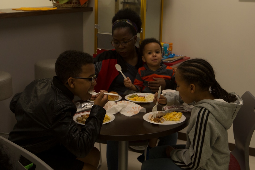 CAMP FOSTER, OKINAWA, Japan – A family dines together during the USO Thanksgiving Dinner Nov. 21 at the USO aboard Camp Foster, Okinawa, Japan.