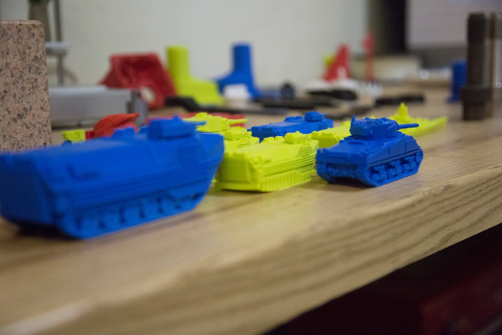 Several 3-D-printed assault vehicle models sit on display in the General Support Maintenance Company (GSM), 3rd Maintenance Battalion, 3rd Marine Logistics Group, as a display of advanced capabilities, Nov. 21 2017, at Camp Kinser, Okinawa, Japan. The Dreamer Flashforge 3-D printer is regularly used at GSM to test form, fit and functionality of equipment and military systems before the finished product is produced out of metal.