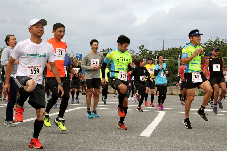 Runners participate in warm up exercises before the 28th Annual Kinser Half Marathon Nov. 19 aboard Camp Kinser, Okinawa, Japan. The run was open to all participants from the local and military communities. About 300 runners came out to run the 13.1-mile race. After the race, runners celebrated their accomplishments with delicious food and drinks.