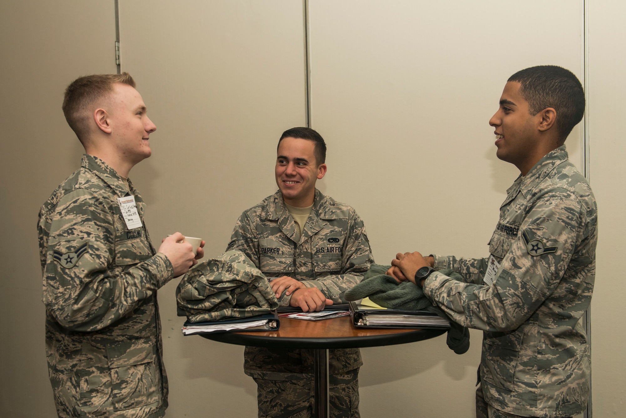 U.S. Air Force Airman 1st Class David Collins, 20th Operations Support Squadron airfield management operations coordinator, left, Airman 1st Class Nathan Parker, middle, and Airman Angel Hernandez, 20th Aircraft Maintenance Squadron tactical aircraft maintainers, chat during a Welcome Weasel Commander Breakfast at the Carolina Skies Club and Conference Center at Shaw Air Force Base, South Carolina, Nov. 20, 2017.