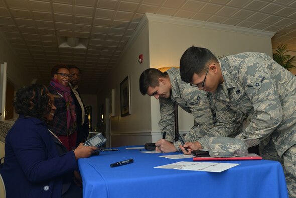 U.S. Airmen sign in at the front desk of the Welcome Weasel Commander Breakfast at the Carolina Skies Club and Conference Center at Shaw Air Force Base, South Carolina, Nov. 20, 2017.