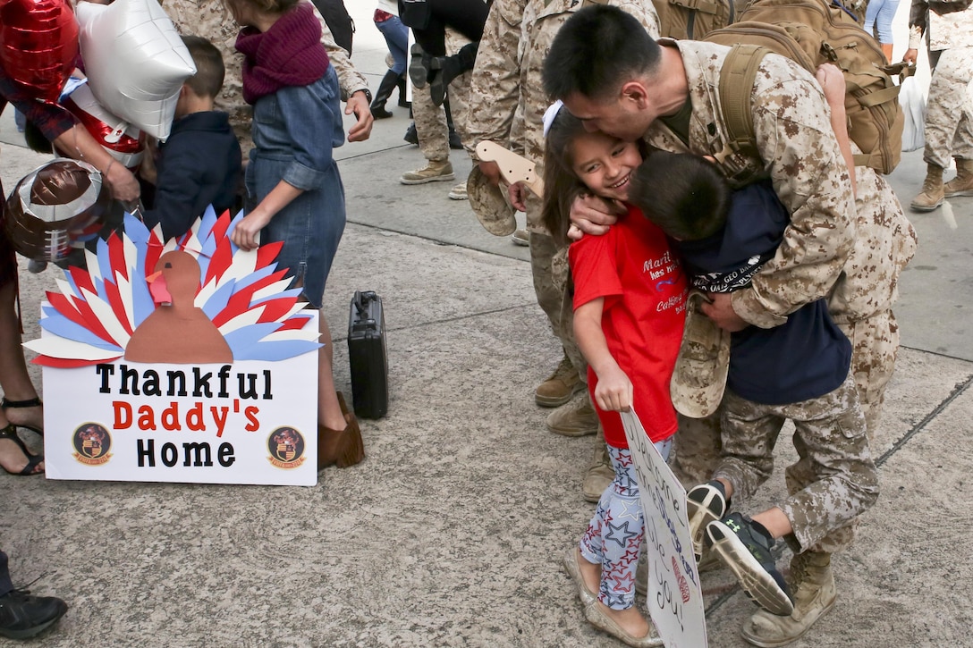A Marine greets his family after returning from a seven month deployment, Nov. 21, aboard Marine Corps Air Station Beaufort. Marine All-Weather Fighter Attack Squadron 224 left for the deployment to support combat operations in the Central Command area of operations, May 8. The Marine is with VMFA(AW)-224.