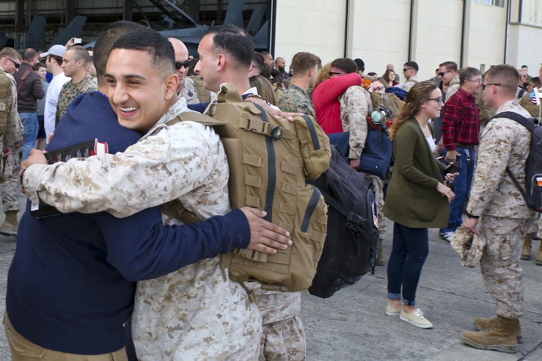 Cpl. Byron Miranda hugs a fellow Marine after returning from a seven month deployment, Nov. 21, aboard Marine Corps Air Station Beaufort. Marine All-Weather Fighter Attack Squadron 224 left for the deployment to support combat operations in the Central Command area of operations, May 8. Miranda is with VMFA(AW)-224.