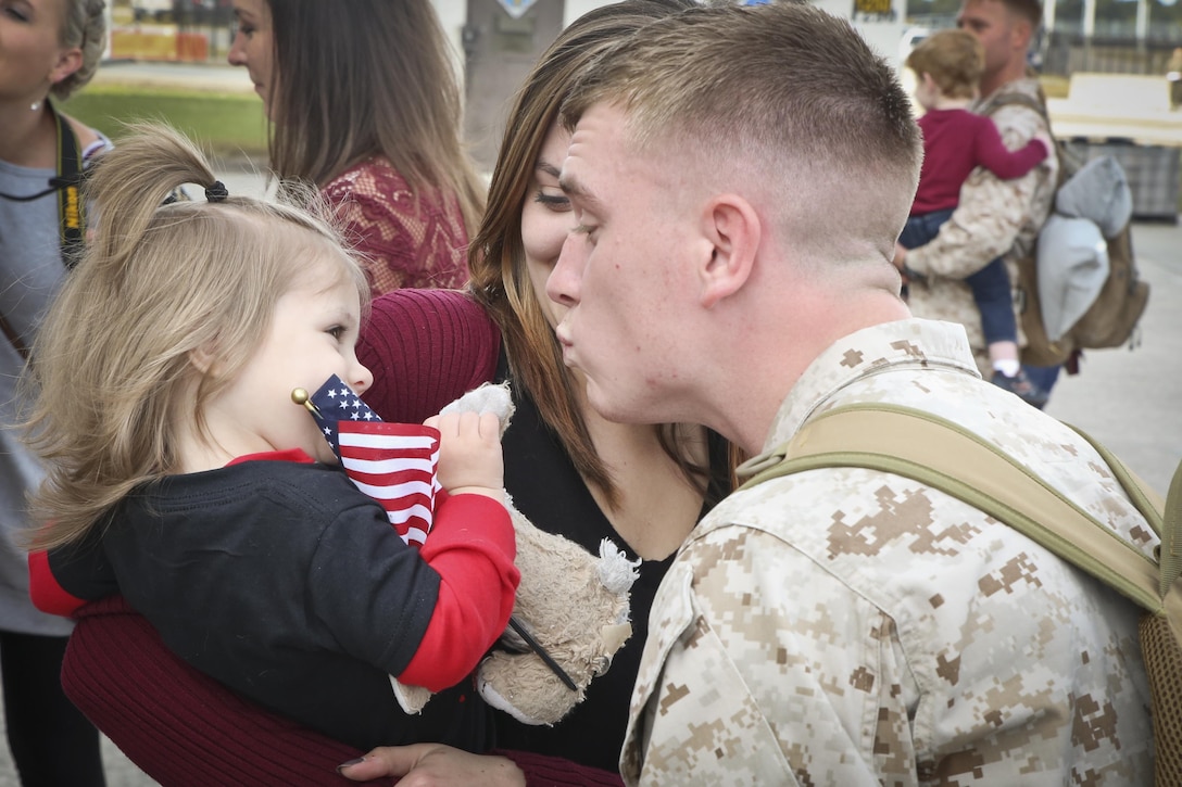 A Marine greets his family after returning from a seven month deployment, Nov. 21, aboard Marine Corps Air Station Beaufort. Marine All-Weather Fighter Attack Squadron 224 left for the deployment to support combat operations in the Central Command area of operations, May 8. The Marine is with VMFA(AW)-224.