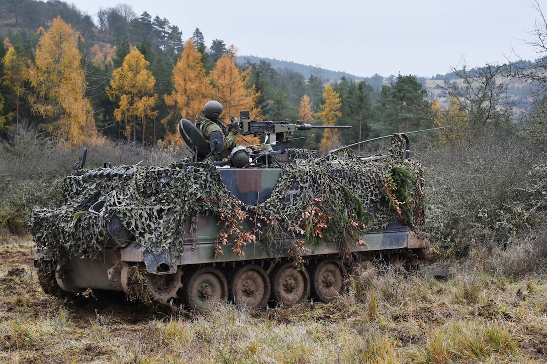 U.S. Army and Lithuanian soldiers maneuver a tracked armored vehicle during Exercise Allied Spirit VII on the 7th Army Training Command’s Hohenfels Training Area, Germany.