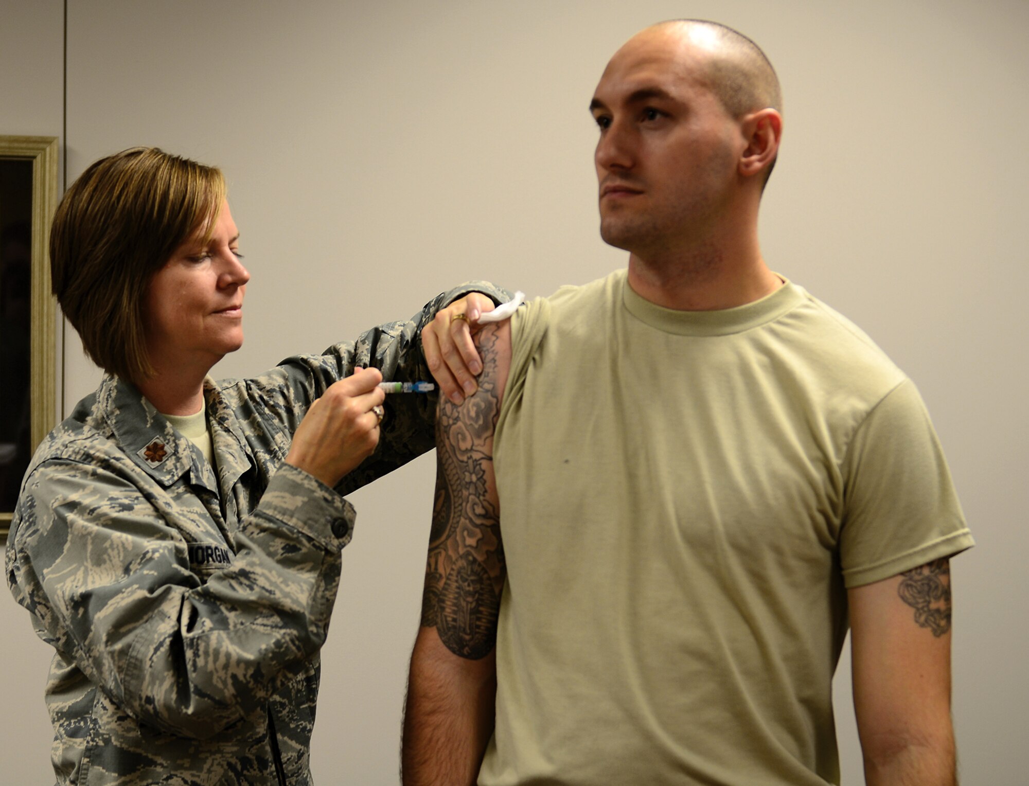 Maj. Amelia Morgan, 445th Aerospace Medicine Squadron, gives a flu vaccination to Master Sgt. Brandon Ashcraft, 445th Civil Engineer Squadron, during the Nov. 5 unit training assembly.