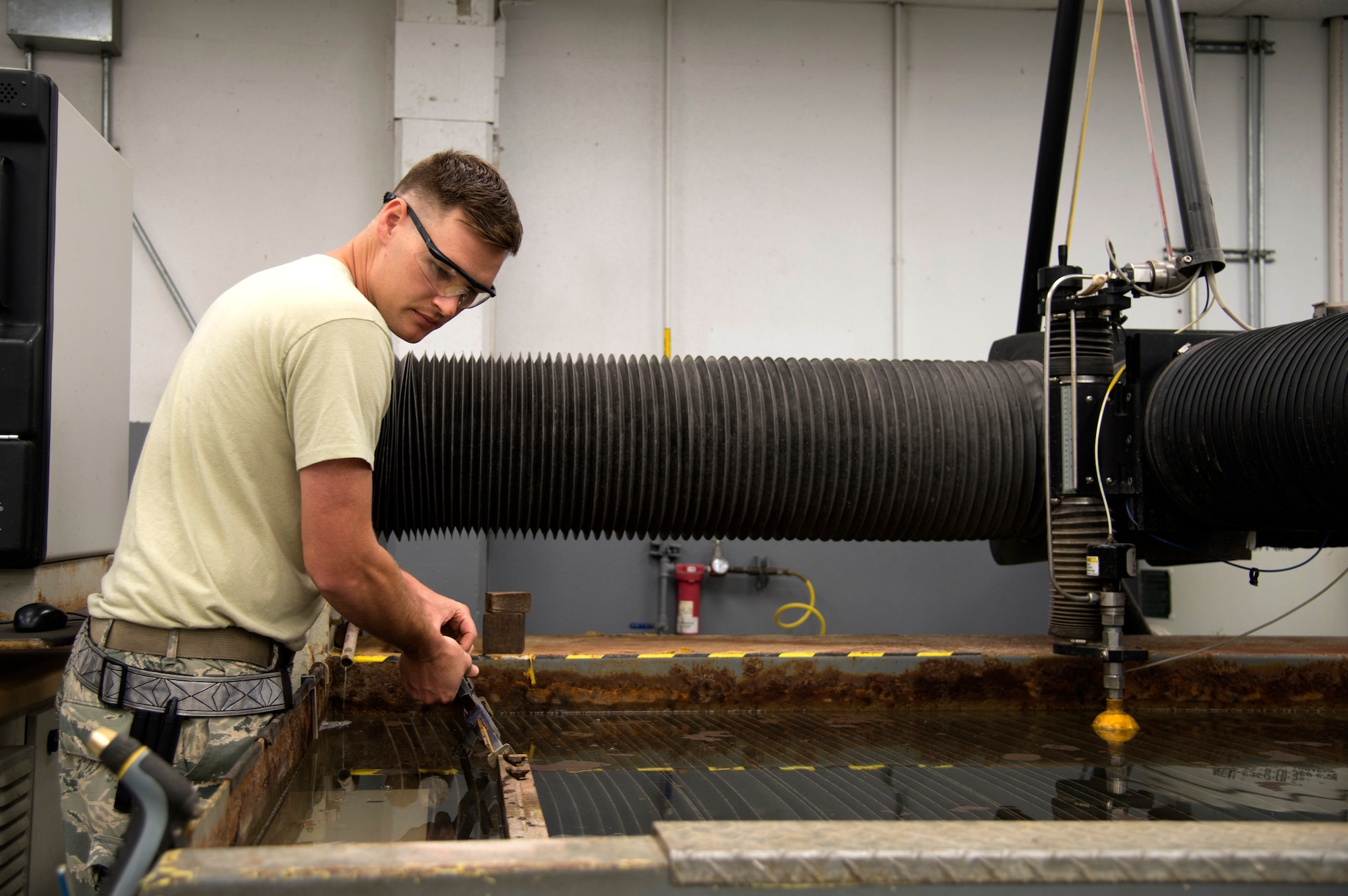 U.S. Air Force Staff Sgt. Eric Griese, an aircraft metals technology technician assigned to the 6th Maintenance Squadron, prepares to cut a design into a piece of sheet metal at MacDill Air Force Base Fla., Nov. 7, 2017.