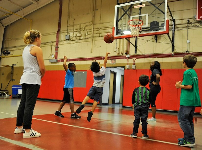 Children participating in the Hoops for Hunger basketball games take practice shots in Sam’s Fitness Center at Joint Base Charleston – Weapons Station, S.C., Nov. 16, 2017.
