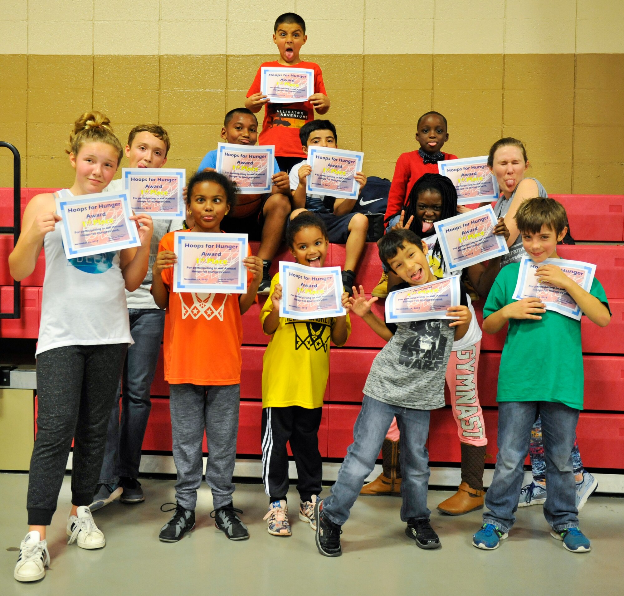 Children pose with Amber Early, Youth Center child and youth program assistant, after receiving participation awards in Sam’s Fitness Center at Joint Base Charleston – Weapons Station, S.C., Nov. 16, 2017.
