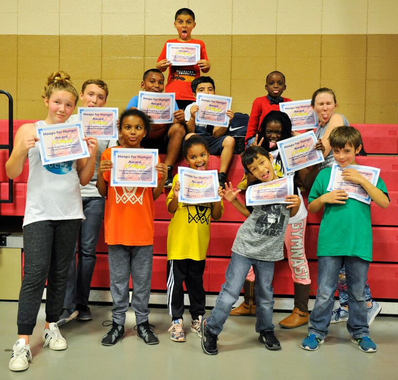 Children pose with Amber Early, Youth Center child and youth program assistant, after receiving participation awards in Sam’s Fitness Center at Joint Base Charleston – Weapons Station, S.C., Nov. 16, 2017.