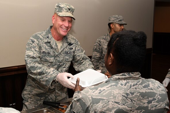 Col. Jim Kellogg, 94th Airlift Wing commander, hands a Thanksgiving meal to an Airman at Dobbins Air Reserve Base, Ga. Nov. 5, 2017. Wing leadership took turns distributing meals at lunchtime during the November drill weekend. (U.S. Air Force photo/Senior Airman Josh Kincaid)