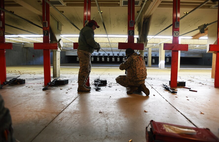 Staff Sgt. Collins Mensing, 22nd Security Forces Squadron combat arms instructor, gives pointers to Staff Sgt. Rolando Leal, 22nd Aircraft Maintenance Squadron electrical and environmental systems journeyman, during an M4 Carbine firing class Nov. 20, 2017, at McConnell Air Force Base, Kansas. Combat arms instructors ensure Airmen are familiarized and fully qualified with their weapon. (U.S. Air Force photo by Airman Michaela R. Slanchik)
