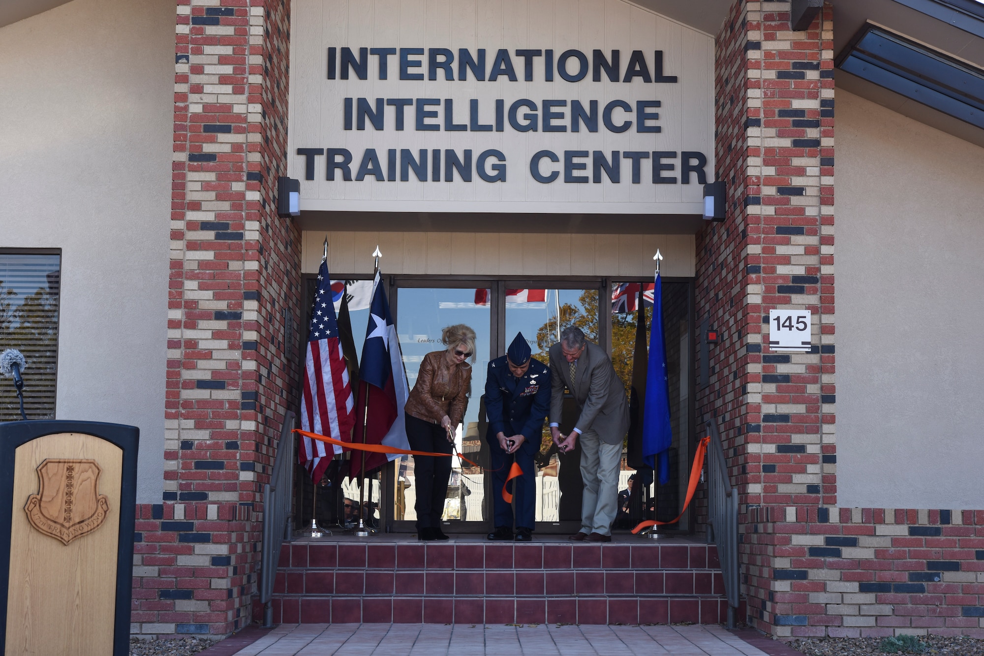 Brenda Gunter, San Angelo mayor, U.S. Air Force Col. Ricky Mills, 17th Training Wing commander, and Stephen Floyd, Tom Green County judge, cut the ribbon for the International Intelligence Training Center on Goodfellow Air Force Base, Texas, Nov. 21, 2017. With aid from both local and state support Goodfellow was able to complete this commitment toward international intelligence training. (U.S. Air Force photo by Airman 1st Class Zachary Chapman/Released)