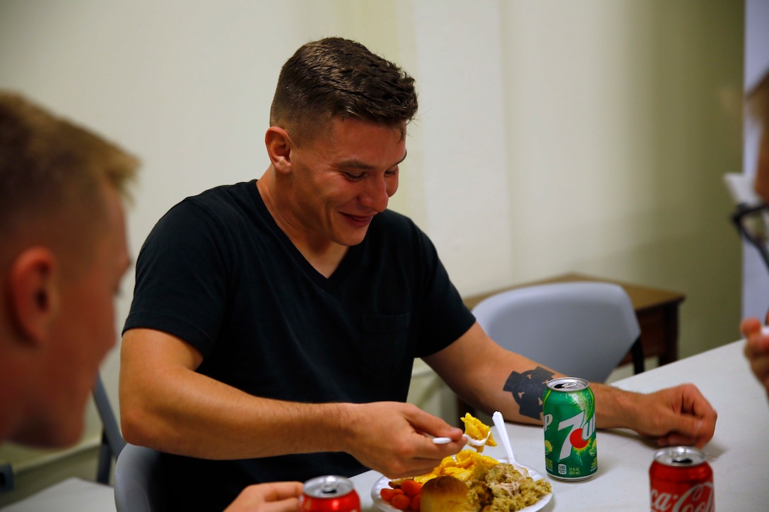 A marine eats Thanksgiving dinner.