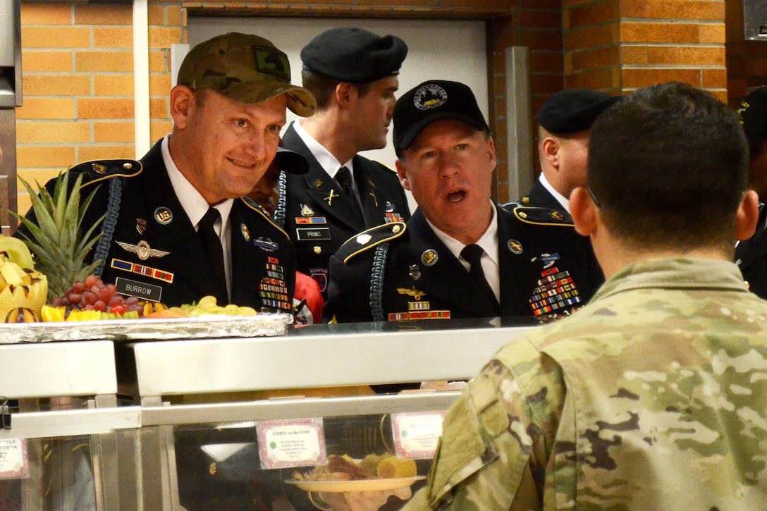 Army command leaders serve soldiers Thanksgiving dinner.