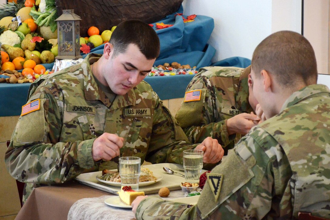 A soldier eats a Thanksgiving meal.