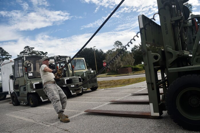 Staff Sgt. Jesse Turner, 628th Logistics Readiness Squadron operator, records and licensing NCO in Charge, prepares to move a forklift Nov. 14, 2017, at Joint Base Charleston, S.C. The 628th LRS transported approximately 38 pallets weighing roughly 130 short tons and issued about two million gallons of fuel for aircraft and ground vehicles in support of Hurricane Maria relief efforts to Puerto Rico.