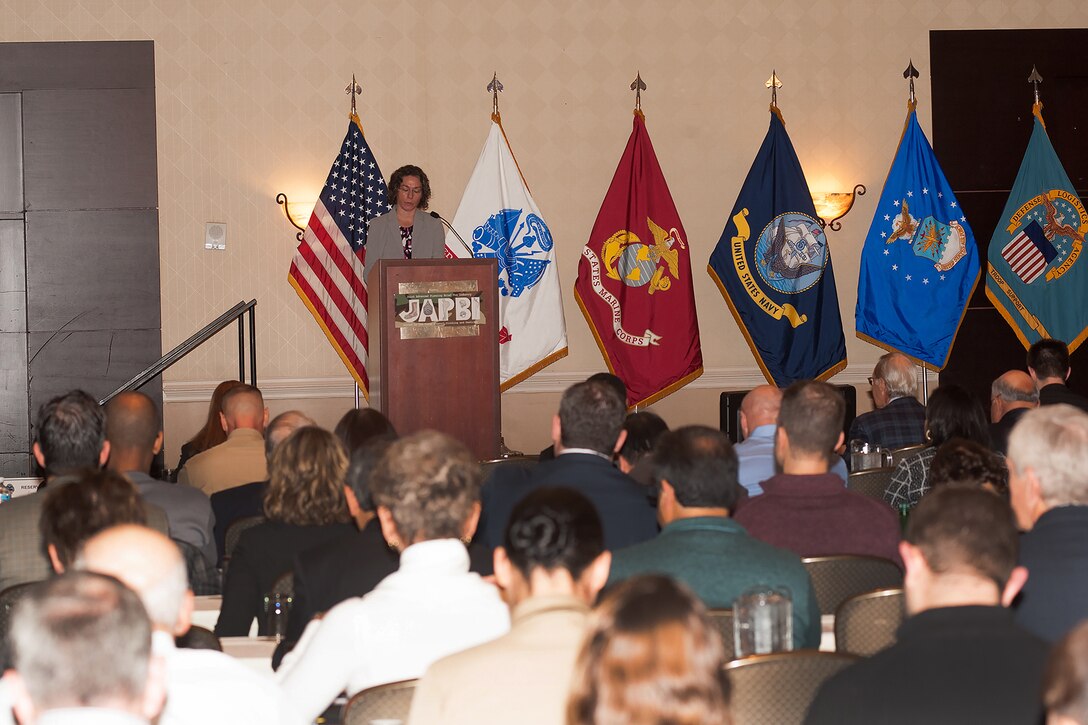 DLA Troop Support Clothing and Textiles Strategic Material Sourcing Division Chief Donna Pointkouski speaks to representatives from nearly 500 U.S. clothing and textiles manufacturers, the military services and government representatives during the third annual Joint Advanced Planning Brief for Industry November 15, 2017. The two-day meeting in Cherry Hill, New Jersey served as an opportunity for the DLA and the military to brief industry partners on their expectations for clothing and individual equipment requirements over the next year.