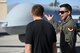 An Airman assigned to the 432nd Wing/432nd Air Expeditionary Wing speaks on the MQ-1 Predator and the MQ-9 Reaper displayed at the 2017 Aviation Nation Air and space Expo, Nov. 11, 2017, at Nellis Air Force Base, Nev. The event showcased some of the Air Force's premier aircraft and personnel dedicated to air superiority.