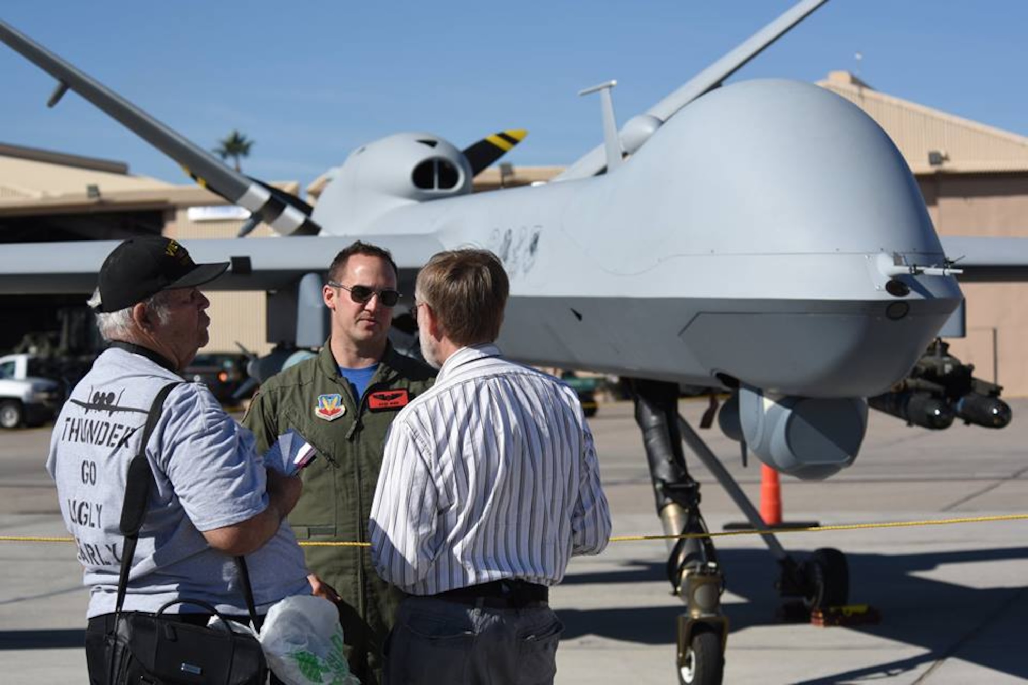 An Airman assigned to the 432nd Wing/432nd Air Expeditionary Wing speaks on the MQ-1 Predator and the MQ-9 Reaper displayed at the 2017 Aviation Nation Air and space Expo, Nov. 11, 2017, at Nellis Air Force Base, Nev. The event showcased some of the Air Force's premier aircraft and personnel dedicated to air superiority.
