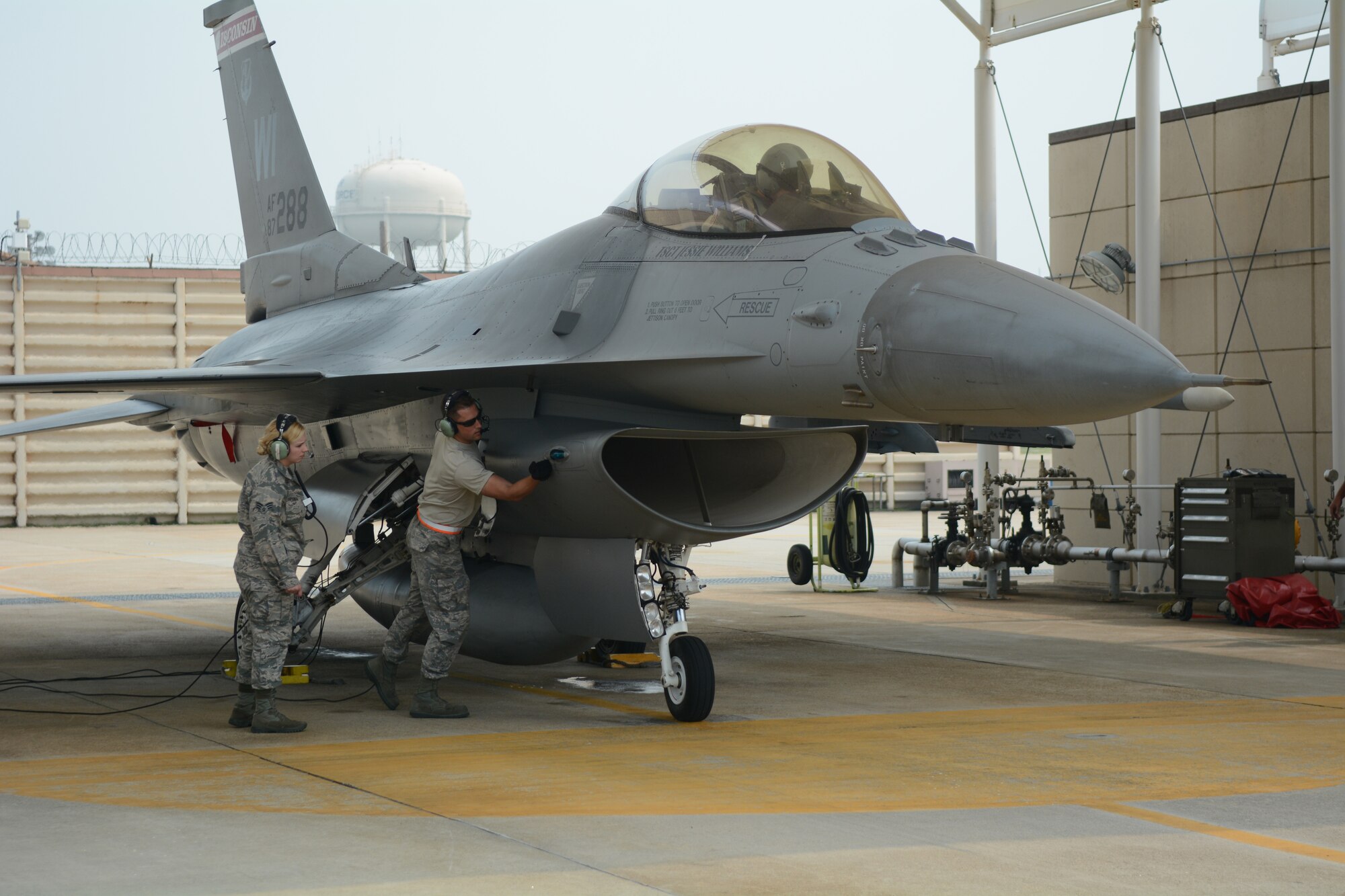 Staff Sgt. Chad Gaffney, a crew chief deployed with the 176th Expeditionary Aircraft Maintenance Unit and Senior Airman Molly Hermanson, an administrative journeyman for the 115th Fighter Wing, prepare an F-16 Fighting Falcon for launch at Kunsan Air Base, Republic of Korea, Sept. 19, 2017. Hermanson was able to assist through a Y-cord attached to her headset that allowed her to walk through the launch alongside Gaffney.  Airmen from the 115th Fighter Wing, Wisconsin Air National Guard, are deployed to Kunsan for a 3-month rotation as part of a Theater Security Package, which helps to maintain a deterrent against threats to regional security and stability.