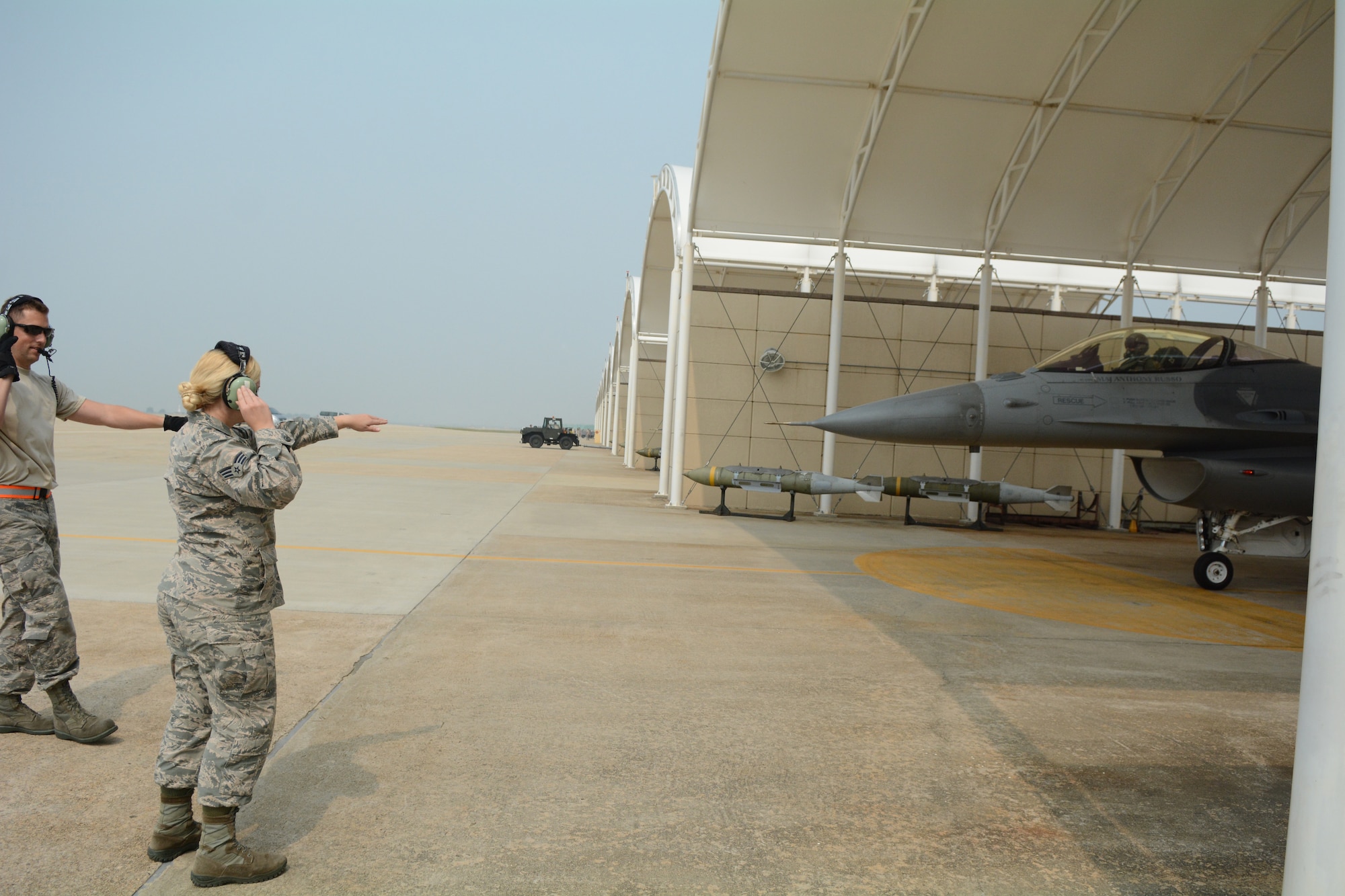 Staff Sgt. Chad Gaffney, a crew chief deployed with the 176th Expeditionary Aircraft Maintenance Unit and Senior Airman Molly Hermanson, an administrative journeyman for the 115th Fighter Wing, prepare an F-16 Fighting Falcon for launch at Kunsan Air Base, Republic of Korea, Sept. 19, 2017. Hermanson was able to assist through a Y-cord attached to her headset that allowed her to walk through the launch alongside Gaffney.  Airmen from the 115th Fighter Wing, Wisconsin Air National Guard, are deployed to Kunsan for a 3-month rotation as part of a Theater Security Package, which helps to maintain a deterrent against threats to regional security and stability. (U.S. Air National Guard photo by Tech. Sgt. Meghan Skrepenski)