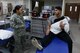 U.S. Air Force Senior Airman Tiffani-Amber Petit, left, a physical therapy technician assigned to the 509th Medical Operations Squadron, discusses post-shoulder surgery treatment with Senior Airman Moses Debraska, a security response member assigned to the 509th Security Forces Squadron, at Whiteman Air Force Base, Mo., Nov. 15, 2017.