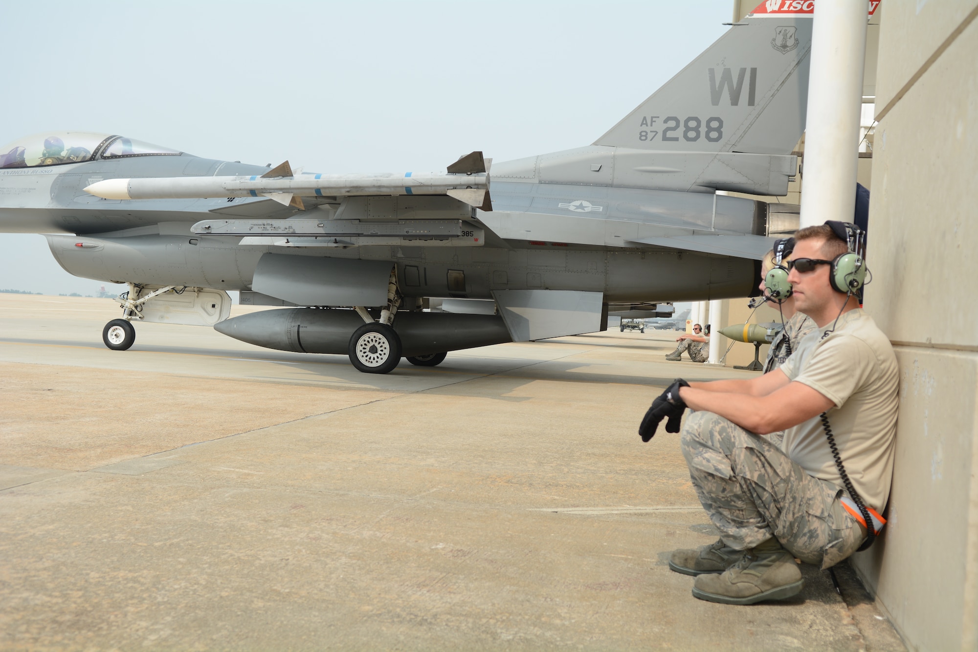 Staff Sgt. Chad Gaffney, a crew chief deployed with the 176th Expeditionary Aircraft Maintenance Unit and Senior Airman Molly Hermanson, an administrative journeyman with the 115th Fighter Wing, prepare an F-16 Fighting Falcon for launch at Kunsan Air Base, Republic of Korea, Sept. 19, 2017. Hermanson was able to assist with the launch through a Y-cord attached to her headset that allowed her to walk through alongside Gaffney.  Airmen from the 115th Fighter Wing, Wisconsin Air National Guard, are deployed to Kunsan for a 3-month rotation as part of a Theater Security Package, which helps to maintain a deterrent against threats to regional security and stability. (U.S. Air National Guard photo by Tech. Sgt. Meghan Skrepenski)