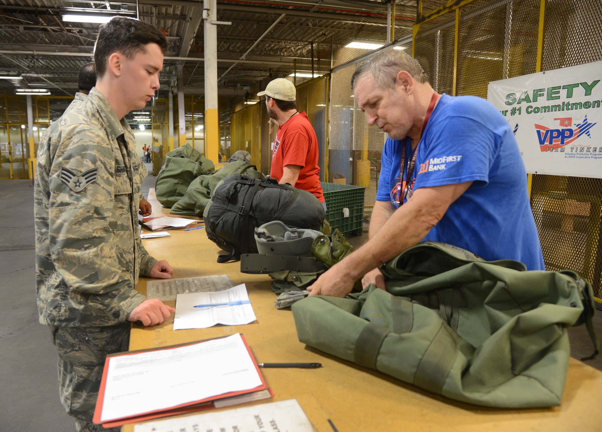 Keith Parks, 72nd Logistics Readiness Squadron, checks the C-Bag of Senior Airman Ryan Shirk, 72nd Force Support Squadron, in the mobility processing line Oct. 4, 2017, Tinker Air Force Base, Oklahoma.