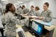 Airman 1st Class Maiesha Buford, 72nd Aerospace Medicine Squadron, gives Capt. Theresa Hall, 72nd Medical Support Squadron, her mobility papers after they were checked for current shot records, public health, mental health, malaria medication, and biological warfare/chemical warfare kits Oct. 4, 2017, Tinker Air Force Base, Oklahoma.