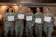 (L to R) Col. Steven Dickerson, 557th Weather Wing commander, Col. Michael Manion, 55th Wing commander and Chief Master Sgt. Brian Kruzelnick, 55th Wing command chief, Col. Robert Billings, 595th Command and Control Group commander and Chief Master Sgt. Margaret Haldie, 595th Command and Control Group command chief show signs displaying their choice of charitable organizations after signing up at the kick-off of the 2017 Combined Federal Campaign on Nov. 21, 2017 at the Patriot Club on Offutt AFB, Neb.