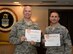 Col. Michael Manion, 55th Wing commander and Chief Master Sgt. Brian Kruzelnick, 55th Wing command chief show signs displaying their choice of charitable organizations after signing up at the kick-off of the 2017 Combined Federal Campaign on Nov. 21, 2017 at the Patriot Club on Offutt AFB, Neb.