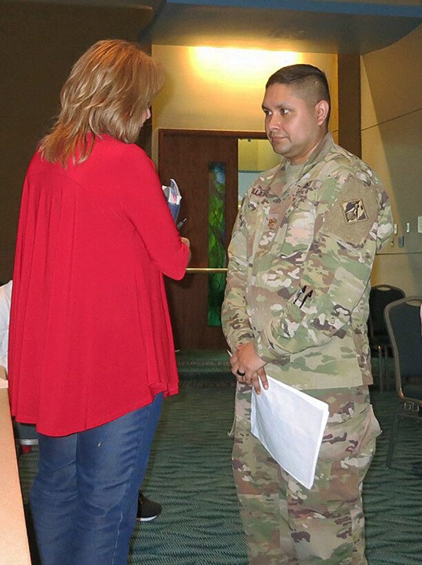 Maj. Juan Villatoro, a contracting officer with the U.S. Army Corps of Engineers, discusses potential recovery-related contracting opportunities with a local business owner during a meeting of the Puerto Rico Business Emergency Operation Center.