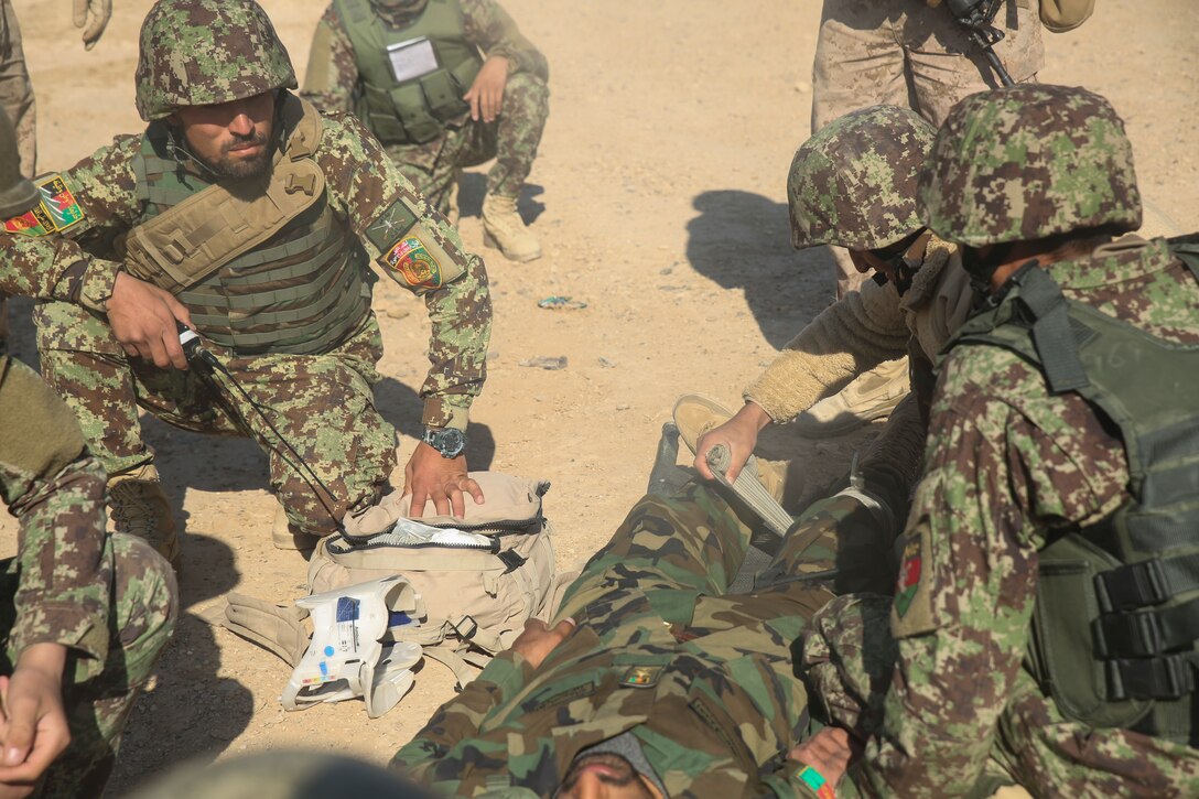 Afghan National Army soldiers with 6th Kandak, 1st Brigade, 215th Corps provide medical care to a notionally wounded soldier during casualty evacuation training at Camp Shorabak, Afghanistan, Nov. 19, 2017. As part of the operational readiness cycle, Afghan instructors at the Helmand Regional Military Training Center held the first iteration of CASEVAC training during the two-month course to help prepare its students for operations against the Taliban. U.S. advisors assigned to multiple train, advise, assist commands from throughout Afghanistan observed the simulation to implement standardized CASEVAC training into their respective RMTCs’ training cycles. (U.S. Marine Corps photo by Sgt. Lucas Hopkins)