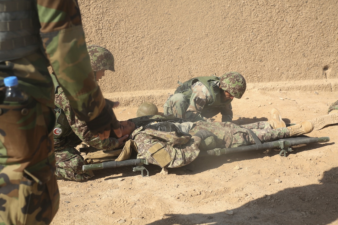 Afghan National Army soldiers with 6th Kandak, 1st Brigade, 215th Corps provide medical care to a notionally wounded soldier during casualty evacuation training at Camp Shorabak, Afghanistan, Nov. 19, 2017. Soldiers with the unit’s 2nd Toli completed the first iteration of CASEVAC training as part of the operational readiness cycle, a two-month course led by Afghan instructors at the Helmand Regional Military Training Center. U.S. advisors with train, advise, assist commands from other provinces in Afghanistan received a first-hand look at the training in order to implement standardized CASEVAC simulation to their respective ORCs. (U.S. Marine Corps photo by Sgt. Lucas Hopkins)