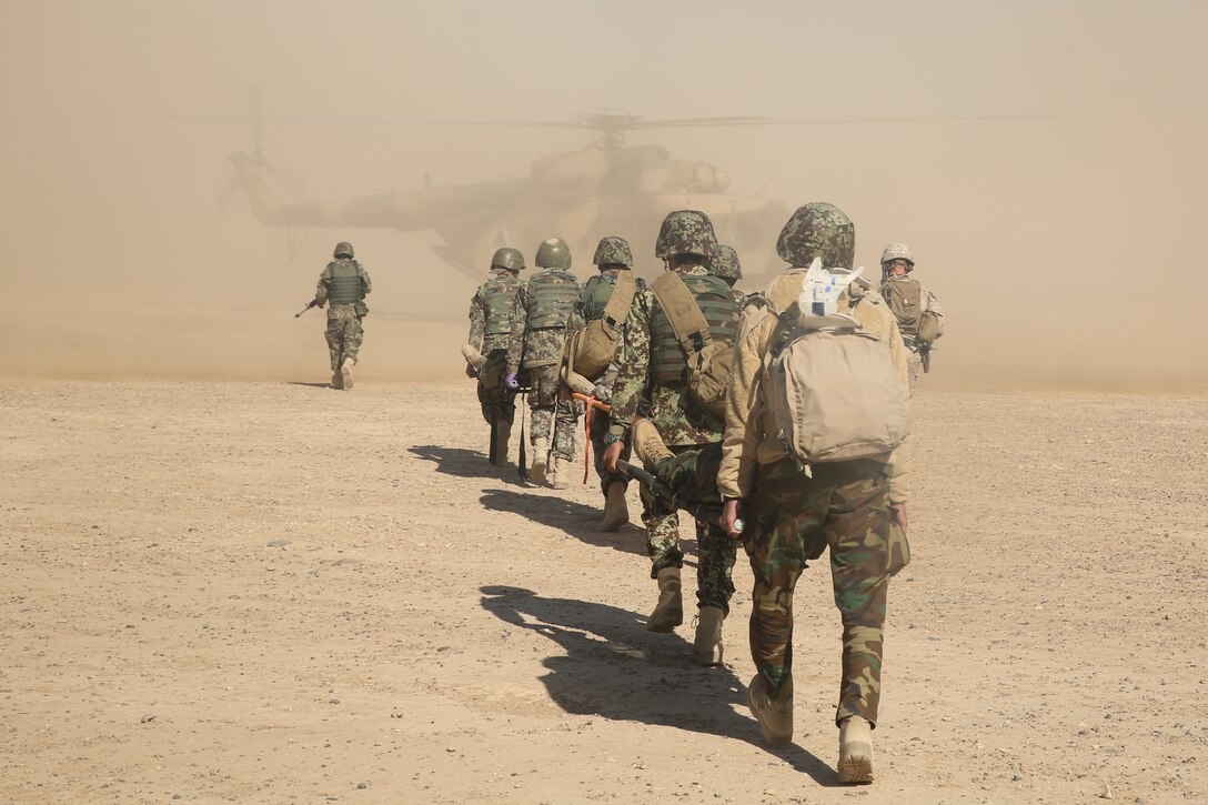 Afghan National Army soldiers with 6th Kandak, 1st Brigade, 215th Corps carry notionally wounded soldiers toward an Mi-17 helicopter during casualty evacuation training at Camp Shorabak, Afghanistan, Nov. 19, 2017. As part of the operational readiness cycle, Afghan instructors at the Helmand Regional Military Training Center held the first iteration of CASEVAC training during the two-month course to help prepare its students for operations against the Taliban. U.S. advisors assigned to multiple train, advise, assist commands from throughout Afghanistan observed the simulation to implement standardized CASEVAC training into their respective RMTCs training cycles. (U.S. Marine Corps photo by Sgt. Lucas Hopkins)
