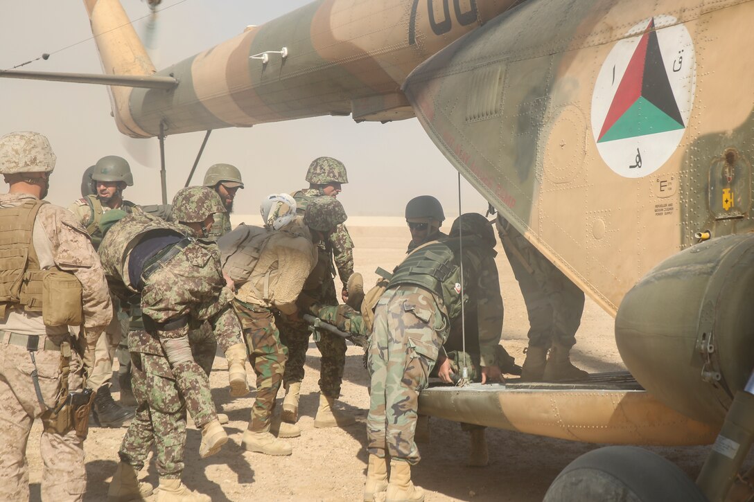 Afghan National Army soldiers with 6th Kandak, 1st Brigade, 215th Corps insert notionally wounded soldiers into an Mi-17 helicopter during casualty evacuation training at Camp Shorabak, Afghanistan, Nov. 19, 2017. The Helmand Regional Military Training Center implemented its first iteration of CASEVAC training using Afghan air assets as part of the operational readiness cycle to help prepare its students for real-world missions. U.S. advisors assigned to various train, advise, assist commands from throughout Afghanistan observed the training in preparation for integrating standardized CASEVAC rehearsals into their unit’s ORCs. (U.S. Marine Corps photo by Sgt. Lucas Hopkins)