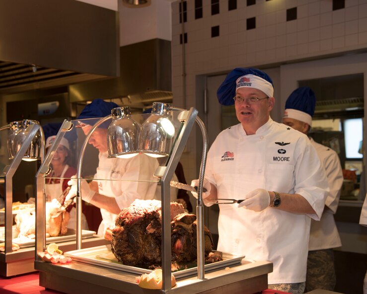 Brig. Gen. Richard Moore, 86th Airlift Wing commander, prepares to serve Airmen during a Thanksgiving meal at Ramstein Air Base, Germany, Nov. 23, 2017