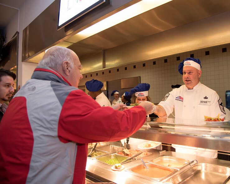 Chief Master Sgt. Aaron Bennett, 86th Airlift Wing command chief, serves Airmen during a Thanksgiving meal at Ramstein Air Base, Germany, Nov. 23, 2017.