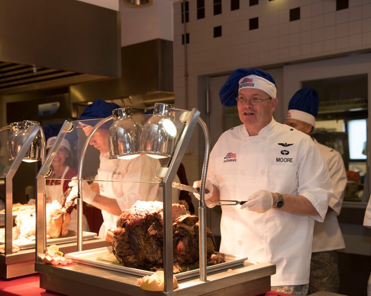 Brig. Gen. Richard Moore, 86th Airlift Wing commander, prepares to serve Airmen during a Thanksgiving meal at Ramstein Air Base, Germany, Nov. 23, 2017.