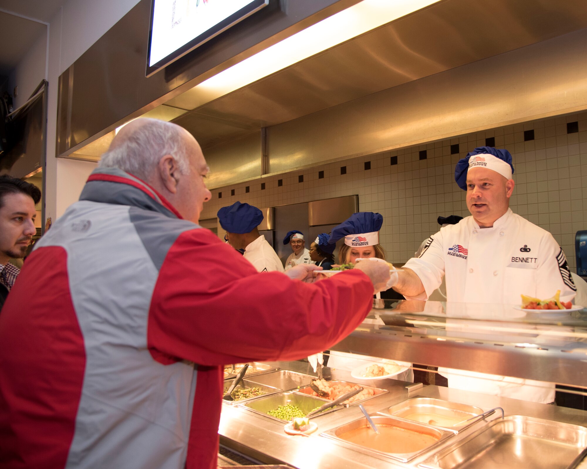 Chief Master Sgt. Aaron Bennett, 86th Airlift Wing command chief, serves meals during Thanksgiving at Ramstein Air Base, Germany, Nov. 23, 2017.