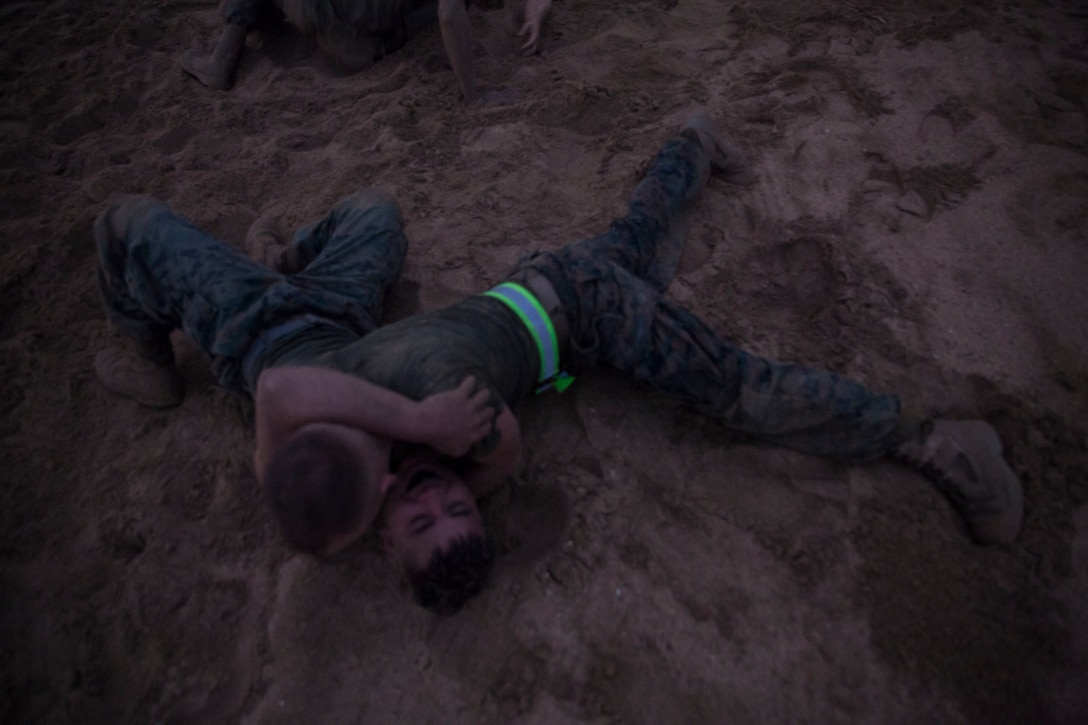U.S. Marines with Combat Assault Company (CAC), 3rd Marine Regiment, conduct ground fighting in conjunction with the 74th anniversary of the Battle of Tarawa, Fort Hase Beach, Marine Corps Base Hawaii (MCBH), Nov. 20, 2017. CAC celebrated the anniversary with a motivational run and beach grappling to promote comradery among the Marines, while understanding the sacrifices at Tarawa. MCBH, along with its tenant units, strives to promote resiliency in remembering the past battles won and to instill in the newest generation what it means to be U.S. Marine.